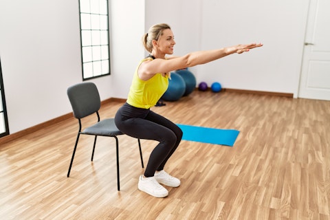 Young blonde girl smiling happy training at sport center.